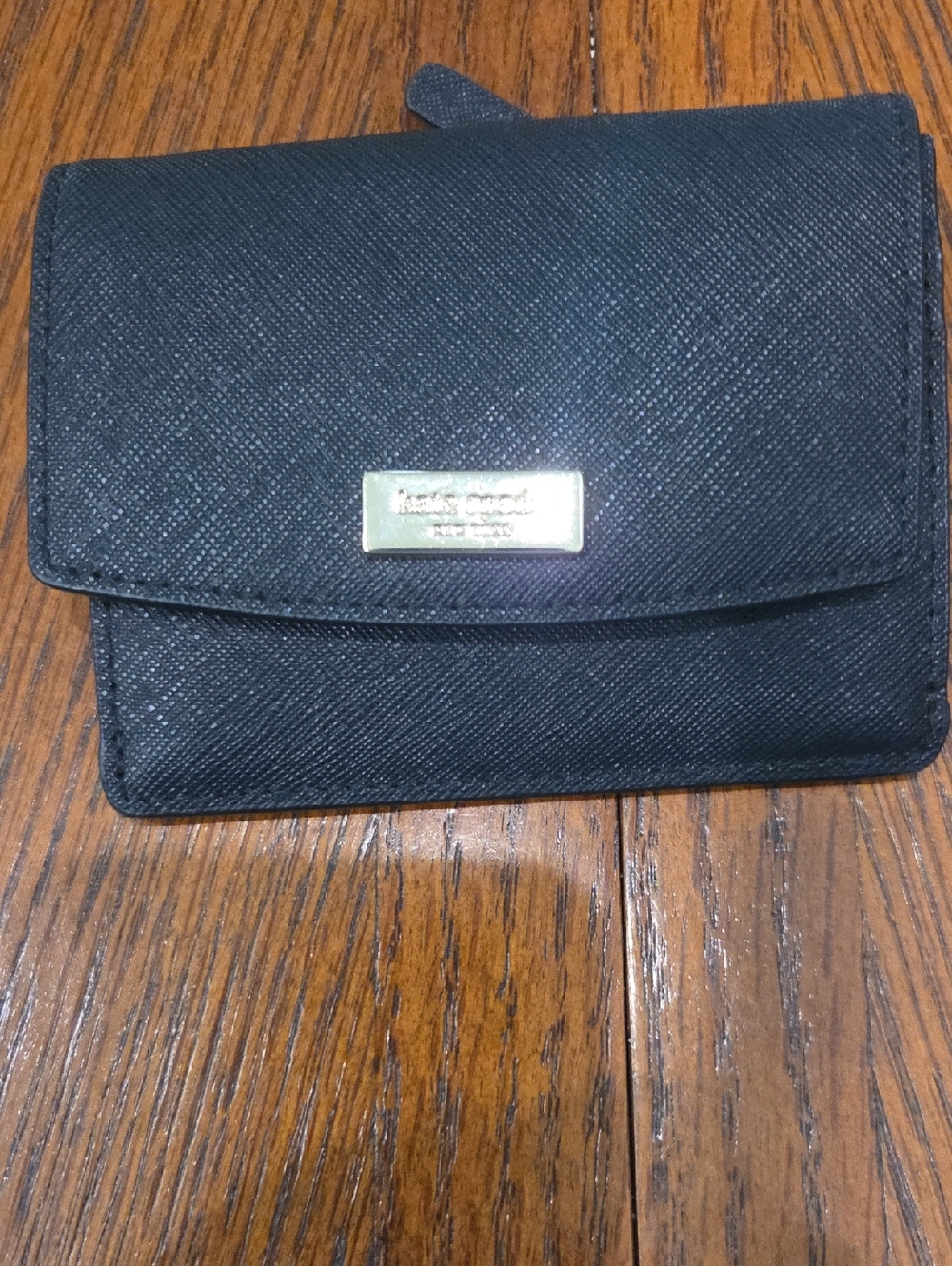 kate spade black saffiano flap wallet with gold plaque